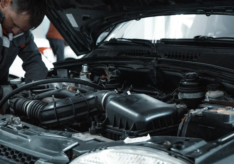 Technician inspecting an engine bay